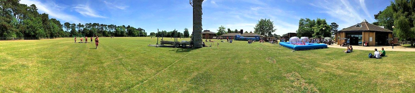 Various activities taking place on the Back Field, with the Pavilion on the right