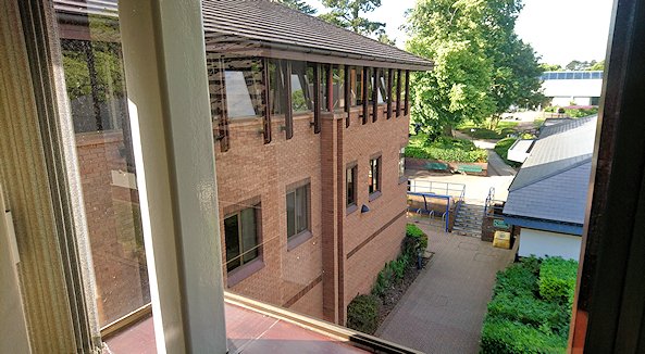 View from second floor of large building, with low-rise structure below