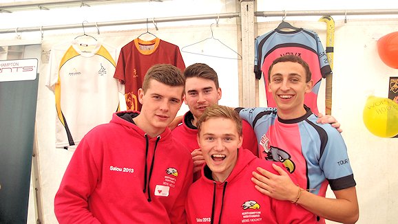 Four happy students at the men's hockey stall at freshers' fair