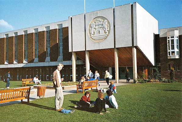 Students relax in the sunshine outside Holdenby and the gold disc above